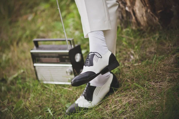 Legs of  groom getting ready in retro shoes