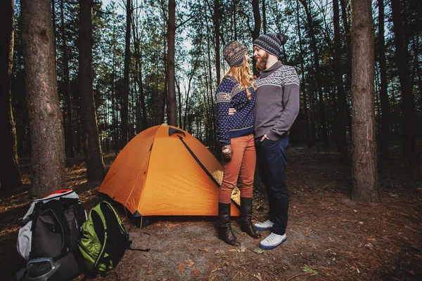 Hikers hugging near the tent