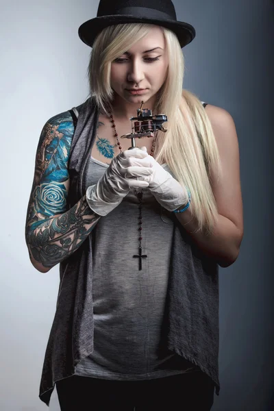 Beautiful girl tattoo artist with tattoos