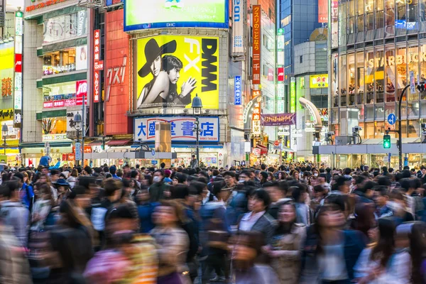 Pedestrians walk at Shibuya Crossing during the holiday season