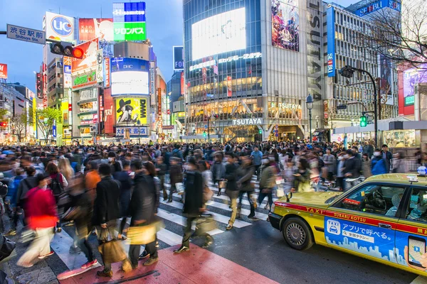 Pedestrians walk at Shibuya Crossing during the holiday season