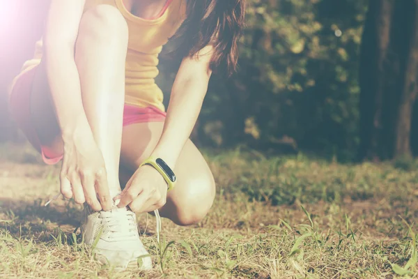 Female sport fitness runner getting ready for jogging outdoors