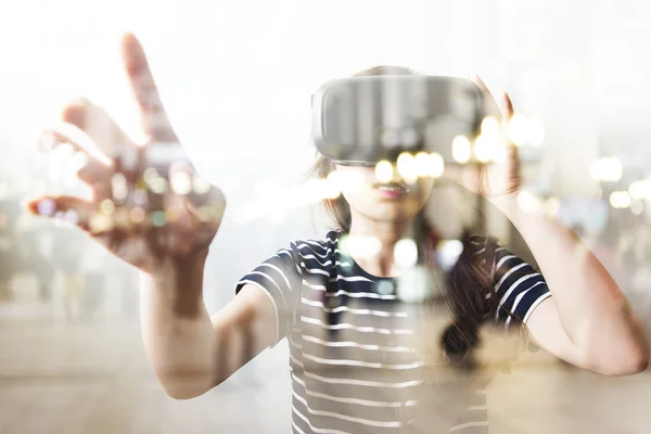 Double exposure of woman using the virtual reality headset