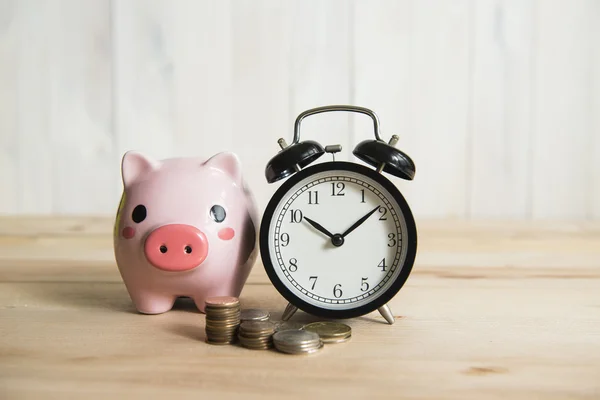 Time is money, clock and coins on white background