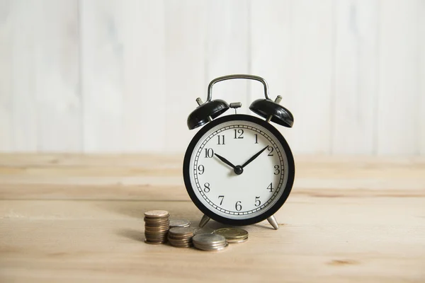 Time is money, clock and coins on white background