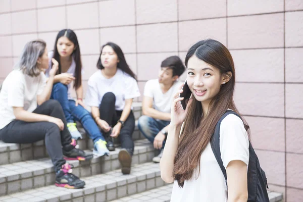 Group of happy teen high school students outdoors