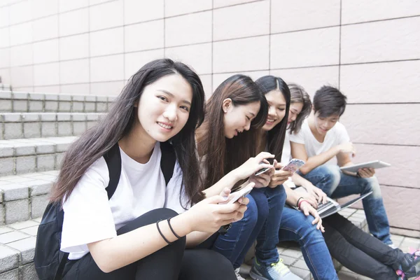 Group of happy teen high school students outdoors