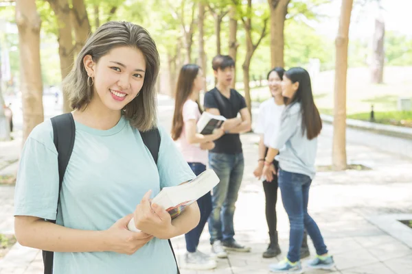 Group of happy teen high school students outdoors