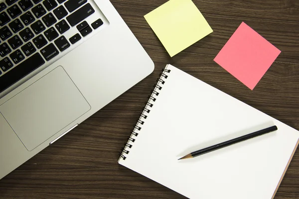 Office table with notepad, computer keyboard, coffee cup , pen ,headphone , sticky notes. View from above with copy space