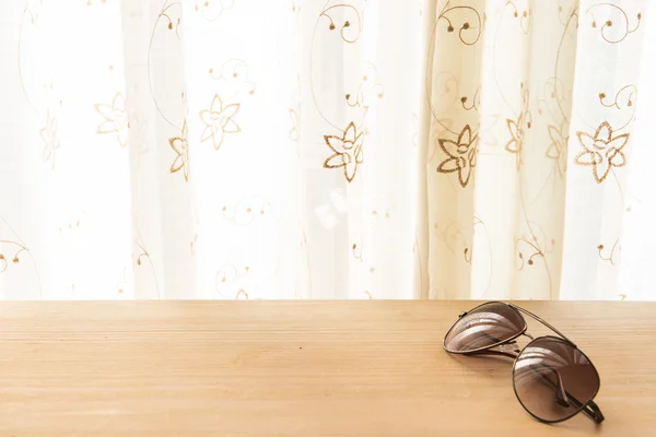 Sun glasses on the wooden background