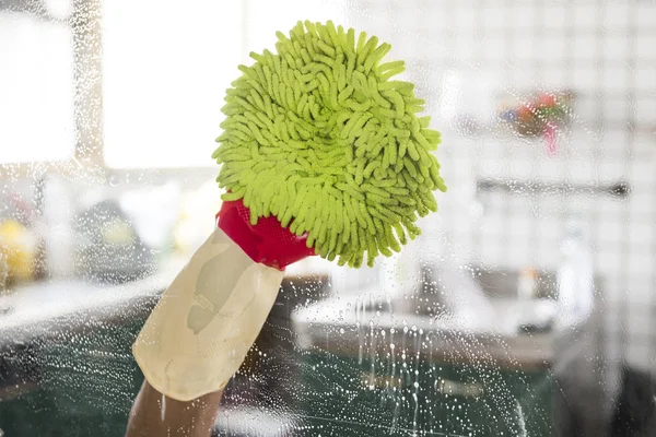 Cleaning - cleaning window pane with detergent, spring cleaning concept