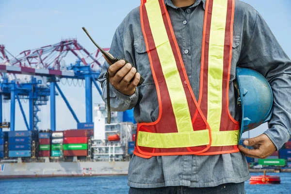 Worker with large crane site and sunset background