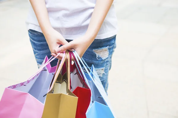 Happy Women holding shopping bags and watching Phone