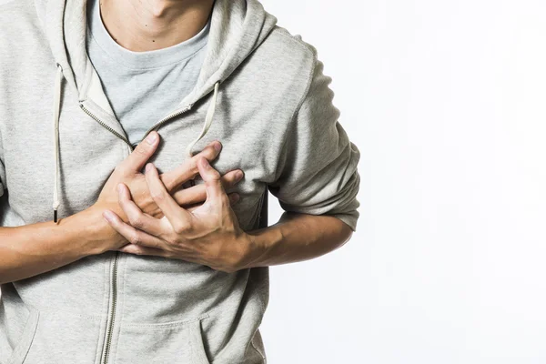 Man feeling heart pain and holding her chest