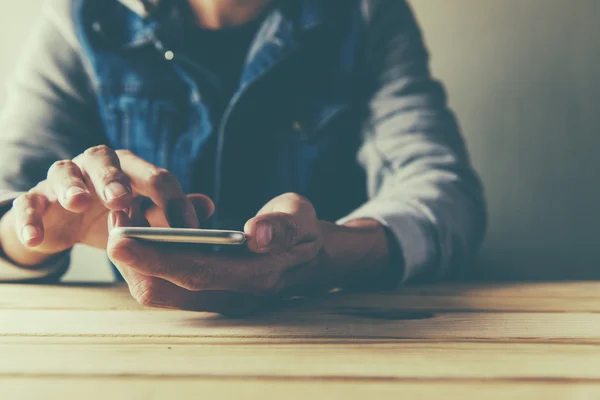 Young man is using a smart phone at home