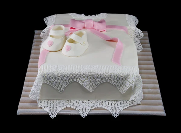 One white cake in the shape of a baby dress