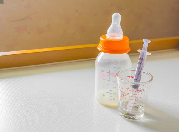 Milk bottle and syringe