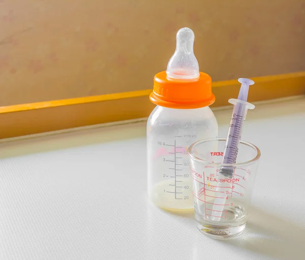 Milk bottle and syringe