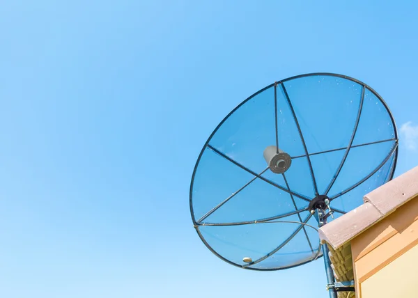Image of satellite on roof with blue sky