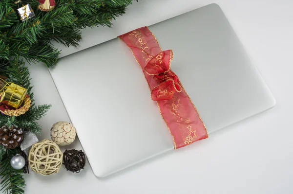 Macbook Christmas present with red, golden ribbon