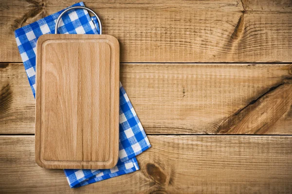 Cutting board on blue kitchen towel with right side copyspace