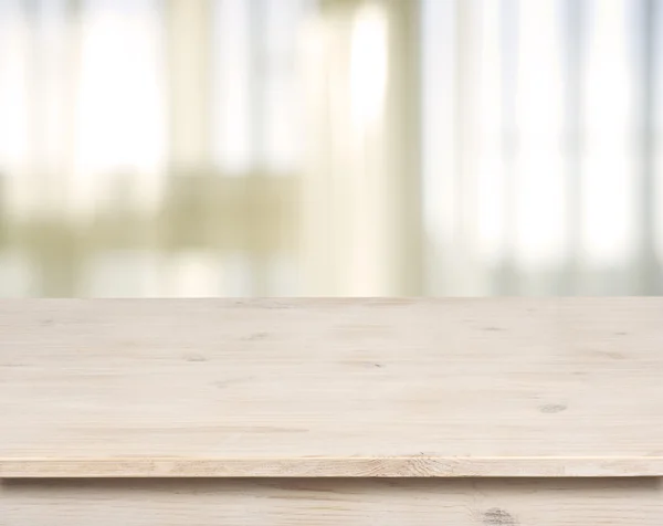 Wooden table on defocuced window with curtain background
