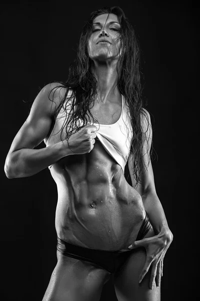 Fitness woman showing abdominal muscles