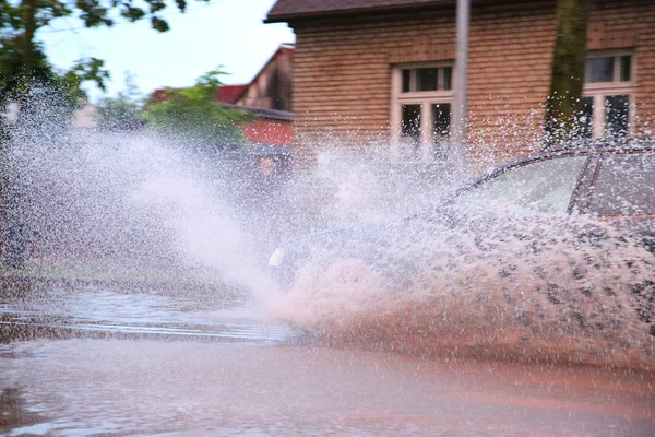 Car drives through a puddle