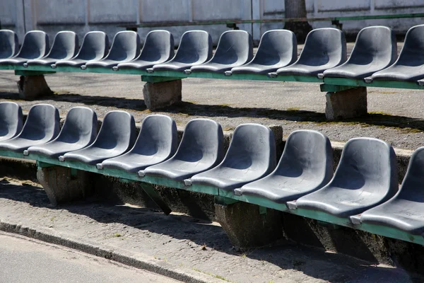 Row of black seats on tribune