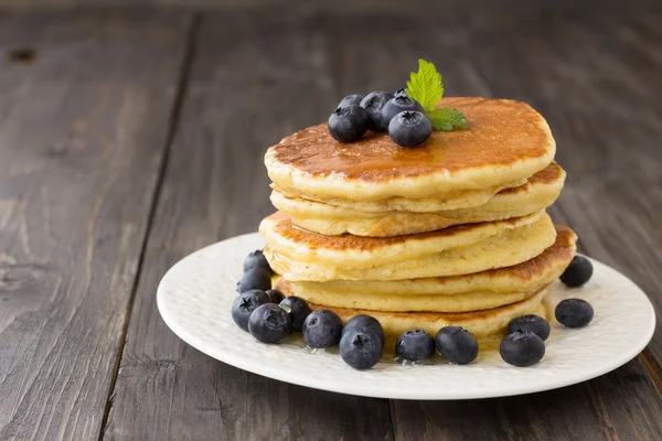 Pancakes with fresh blueberries and honey