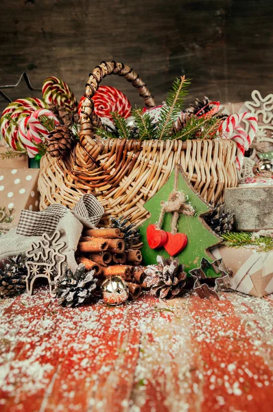Merry Christmas composition.Christmas gifts, basket, Red wooden background.