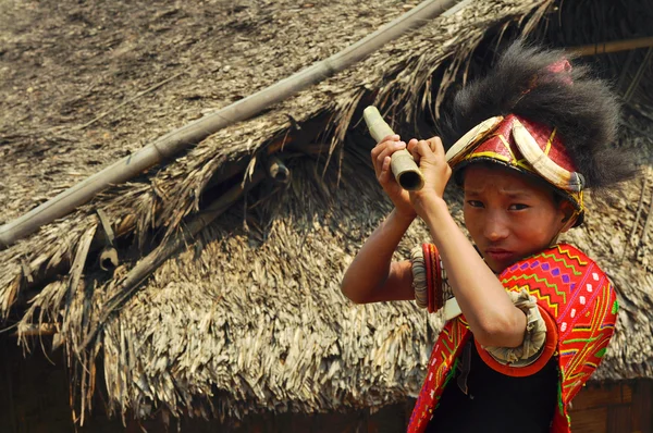 Native boy aiming with stick in Nagaland, India