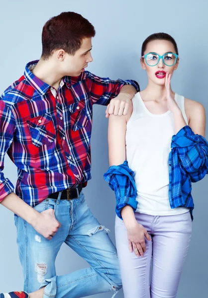 Young couple in fashion casual wear. Plaid shirt and jeans. Tren