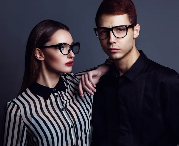 Eyewear concept. Portrait of gorgeous fashion couple in black cl