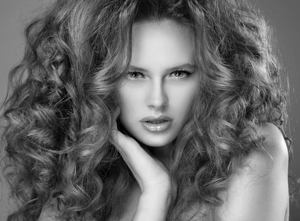 Portrait of beautiful blonde woman with curly hairstyle