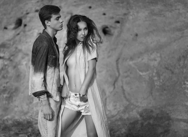 Fashion portrait of young beautiful couple in casual jeans cloth