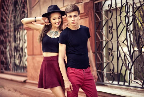 Fashion portrait of young beautiful trendy couple in casual  clo