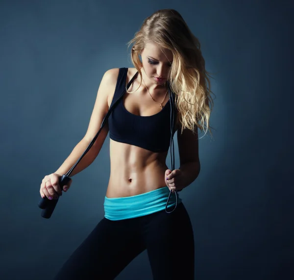 Portrait of attractive sexy fitness blond girl with jumping rope