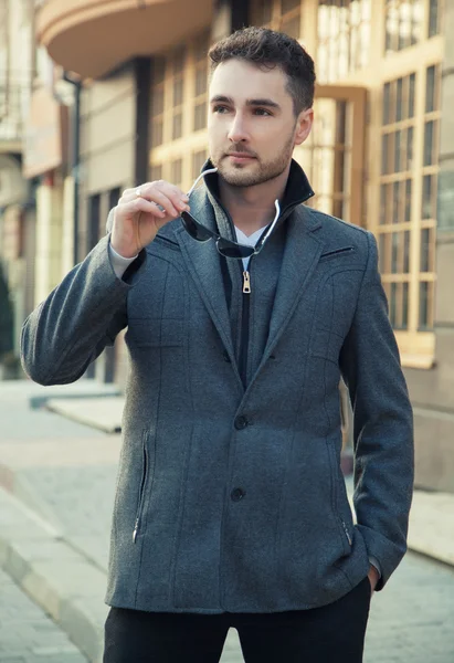 Street fashion.Portrait of handsome man in trendy casual coat an