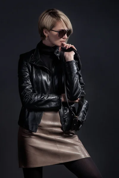 Fashion photo of beautiful lady in leather jacket and slirt with