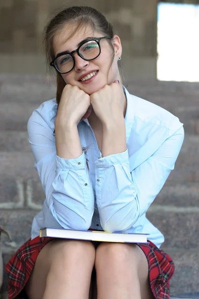 Girl student with books in her hand