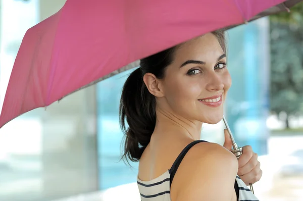 Woman goes under an umbrella