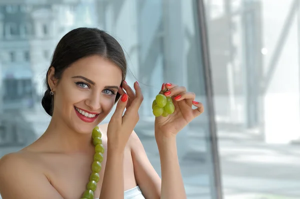 Turkish woman made decorations from the living grapes.