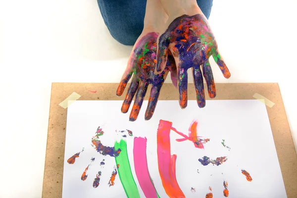 Girl shows hands in the paint