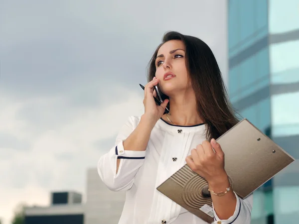 Business woman in formal clothes talking on the phone