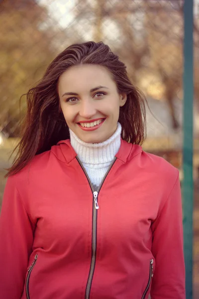 Portrait of a girl in a red track suit