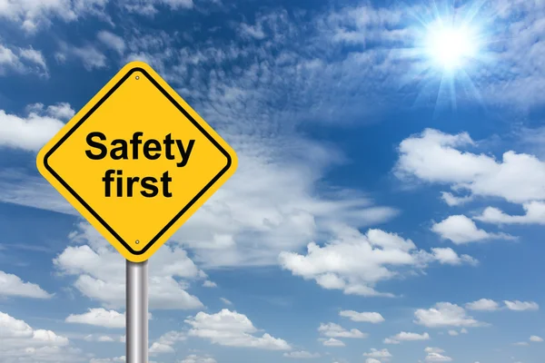 Safety first sign banner and clouds blue sky background
