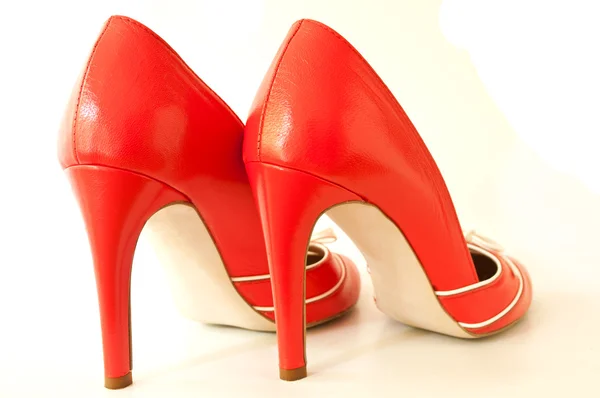 Closeup of red stilettos shoes on white background