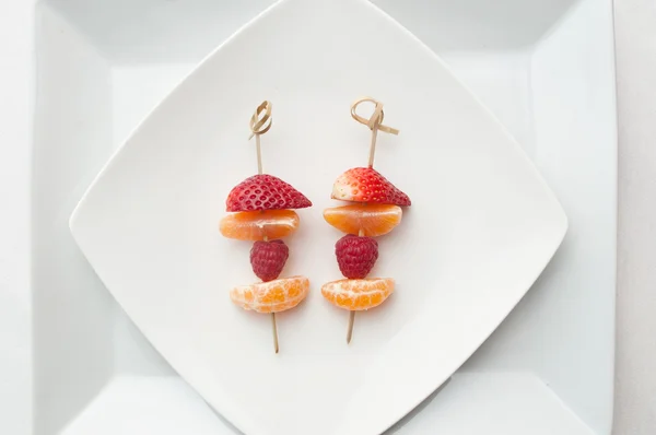 Fruits skewer presentation in a plate