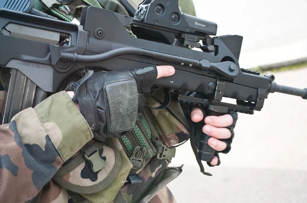 Detail of french soldier armed with the famas french shotgum